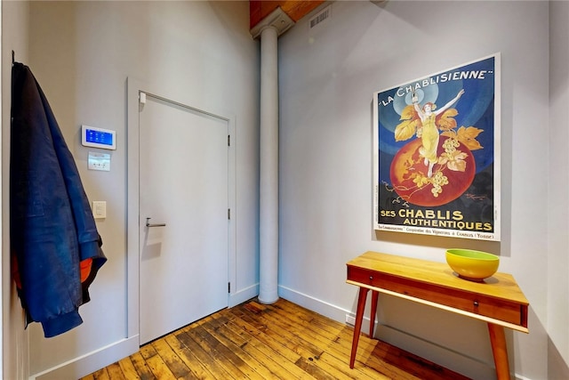 foyer featuring hardwood / wood-style flooring and baseboards