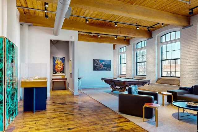 playroom featuring rail lighting, hardwood / wood-style floors, wooden ceiling, pool table, and beam ceiling
