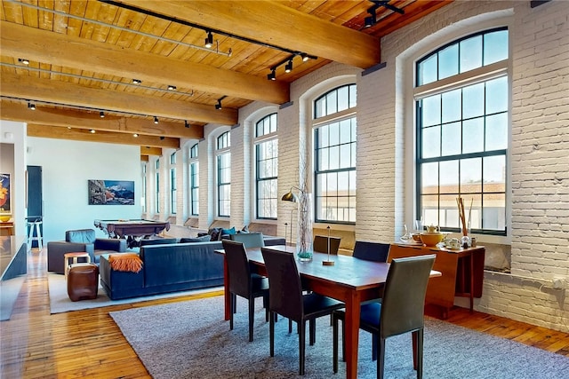 dining space featuring rail lighting, wood ceiling, wood-type flooring, billiards, and beam ceiling