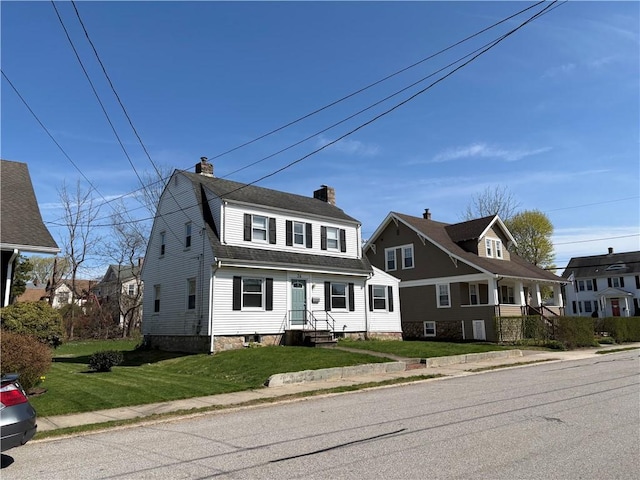 24 George St, Westerly, RI 02891 - dutch colonial featuring a chimney, a front lawn, and roof with shingles