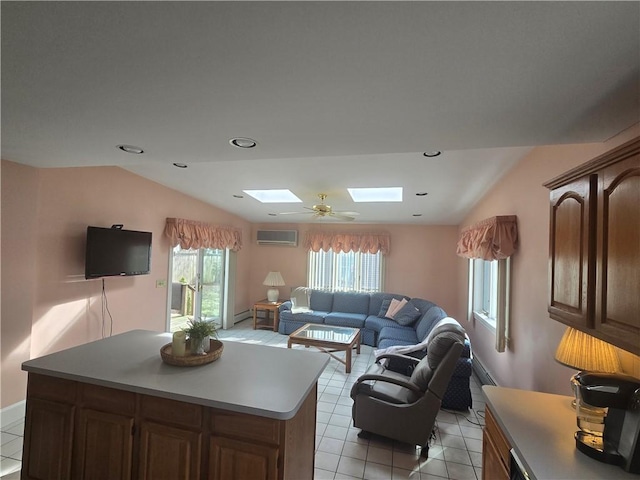 living area featuring a skylight, a wall mounted AC, light tile patterned floors, baseboards, and lofted ceiling
