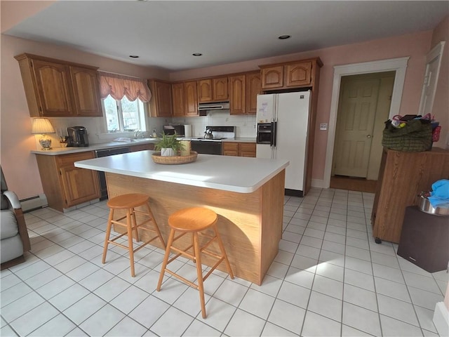 kitchen featuring white refrigerator with ice dispenser, range with electric cooktop, a sink, and brown cabinets