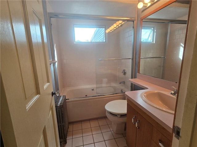 bathroom featuring radiator, tile patterned floors, healthy amount of natural light, and vanity