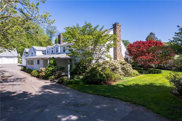 2 Cherry Ln, Bristol, RI 02809 - view of side of property with a yard, a garage, a chimney, and an outdoor structure