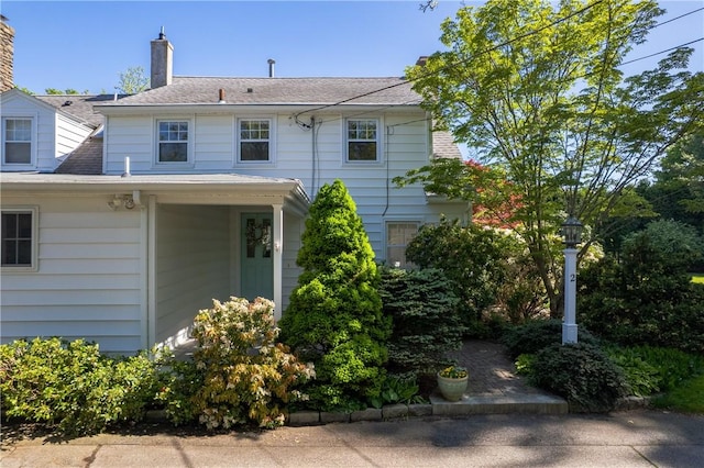 2 Cherry Ln, Bristol, RI 02809 - back of property featuring a chimney and a shingled roof