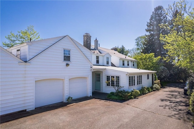 2 Cherry Ln, Bristol, RI 02809 - traditional-style house with a chimney, driveway, and an attached garage