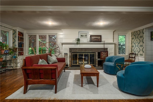 2 Cherry Ln, Bristol, RI 02809 - living area featuring a glass covered fireplace, crown molding, a textured ceiling, and wood finished floors