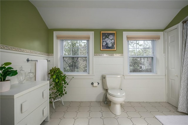 2 Cherry Ln, Bristol, RI 02809 - bathroom with lofted ceiling, plenty of natural light, toilet, and a wainscoted wall