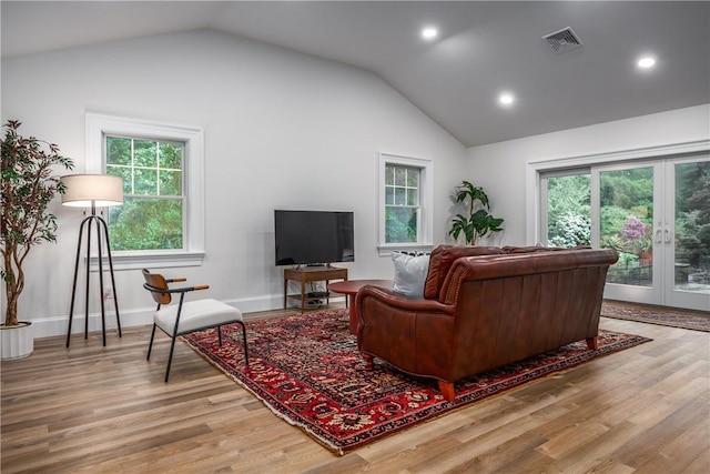2 Cherry Ln, Bristol, RI 02809 - living area with lofted ceiling, wood finished floors, recessed lighting, french doors, and baseboards