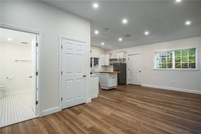 2 Cherry Ln, Bristol, RI 02809 - unfurnished living room with wood finished floors, baseboards, vaulted ceiling, and recessed lighting