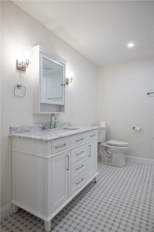 2 Cherry Ln, Bristol, RI 02809 - bathroom with toilet, vanity, and baseboards