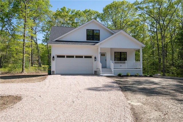 145 Wolf Rock Rd, Exeter, RI 02822 - modern inspired farmhouse with covered porch, driveway, a shingled roof, and a garage
