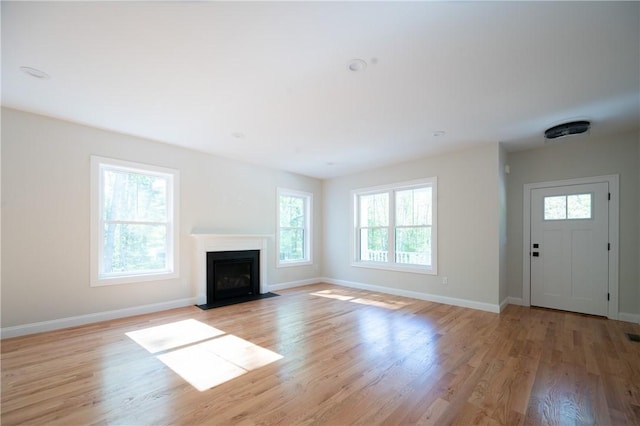145 Wolf Rock Rd, Exeter, RI 02822 - unfurnished living room with plenty of natural light, light wood-style floors, and baseboards