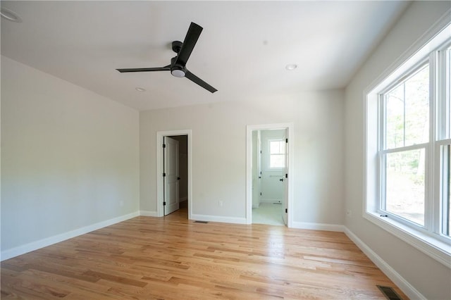145 Wolf Rock Rd, Exeter, RI 02822 - unfurnished bedroom featuring multiple windows, light wood-style floors, and baseboards