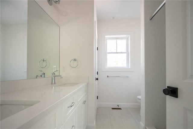 145 Wolf Rock Rd, Exeter, RI 02822 - full bath with toilet, tile patterned floors, double vanity, and baseboards