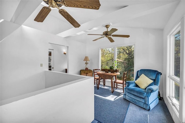 living area featuring a ceiling fan, carpet, and lofted ceiling