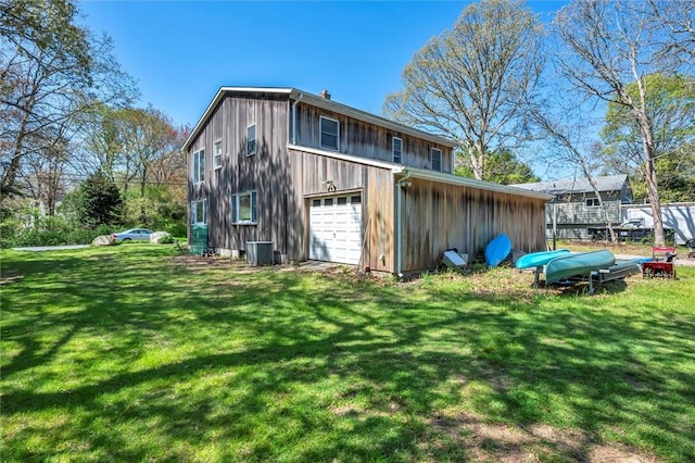 back of house featuring cooling unit, board and batten siding, and a lawn