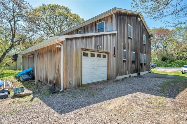 detached garage with gravel driveway