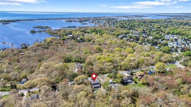 aerial overview of property's location with a large body of water and a heavily wooded area