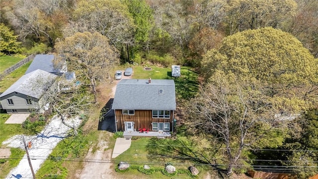 aerial view of property and surrounding area featuring a forest
