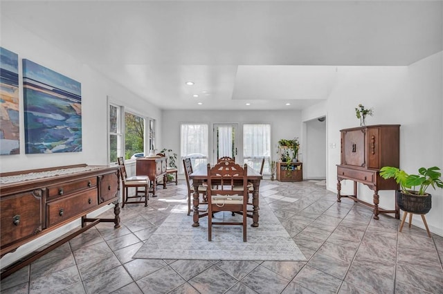 dining space featuring light marble finish flooring, recessed lighting, and baseboards