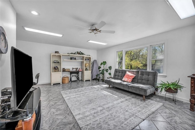 living area featuring ceiling fan, baseboards, and recessed lighting