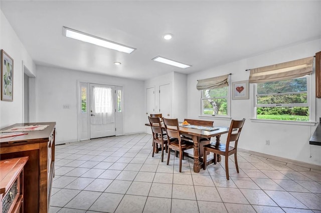 dining room featuring light tile patterned floors, baseboards, and recessed lighting