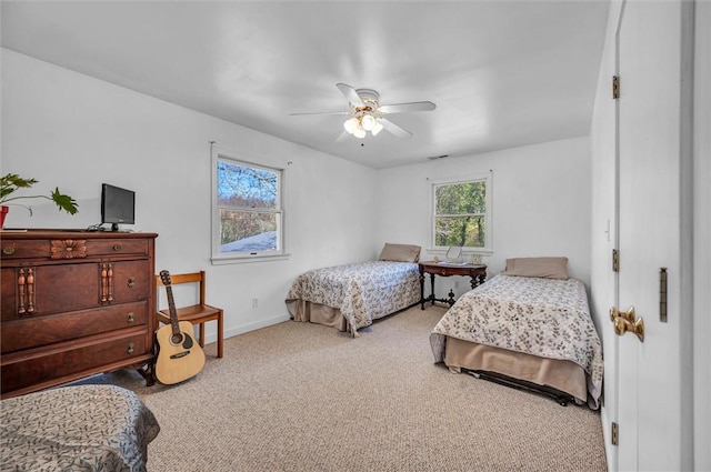 carpeted bedroom featuring baseboards and ceiling fan