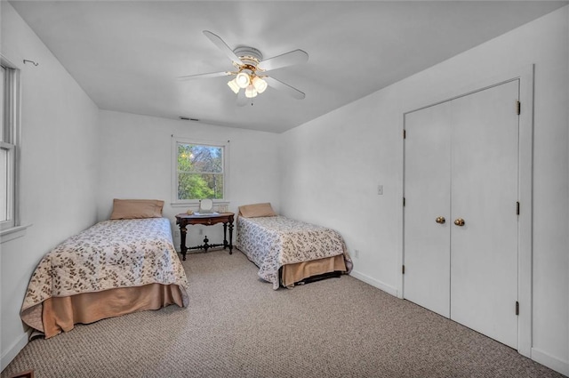 carpeted bedroom featuring baseboards and ceiling fan