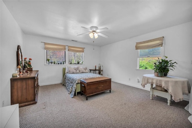 bedroom with multiple windows, carpet floors, baseboards, and a ceiling fan