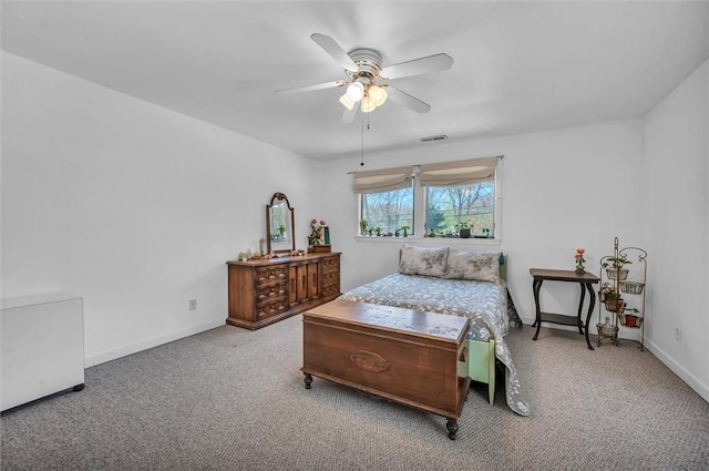 carpeted bedroom featuring baseboards and a ceiling fan