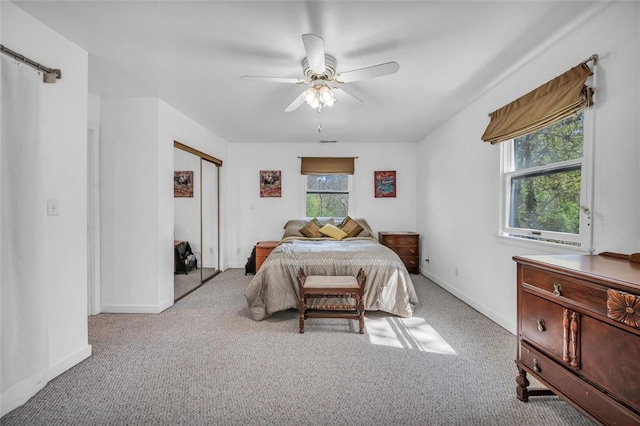 bedroom featuring carpet, ceiling fan, baseboards, and a closet