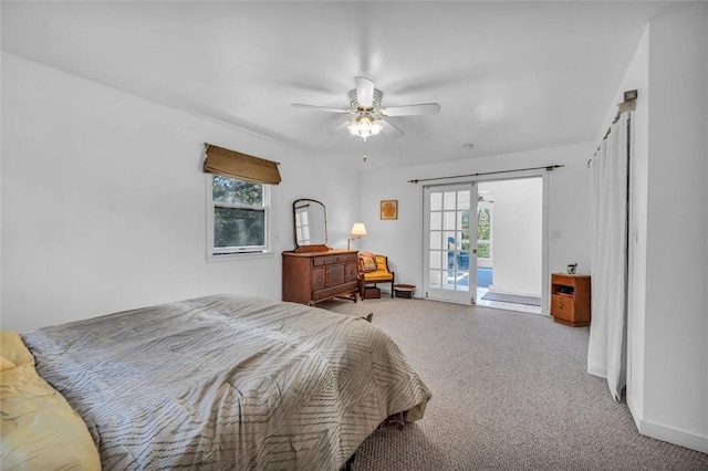 bedroom featuring carpet floors, multiple windows, and access to outside