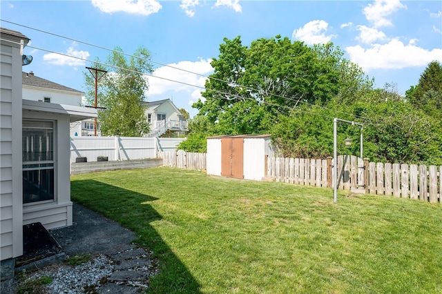view of yard featuring a storage unit and an outbuilding