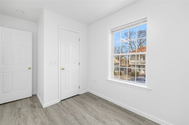 38 Brook St, Central Falls, RI 02863 - unfurnished bedroom with baseboards and wood finished floors