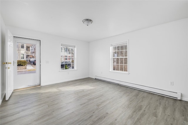 38 Brook St, Central Falls, RI 02863 - spare room featuring a baseboard radiator, wood finished floors, and baseboards