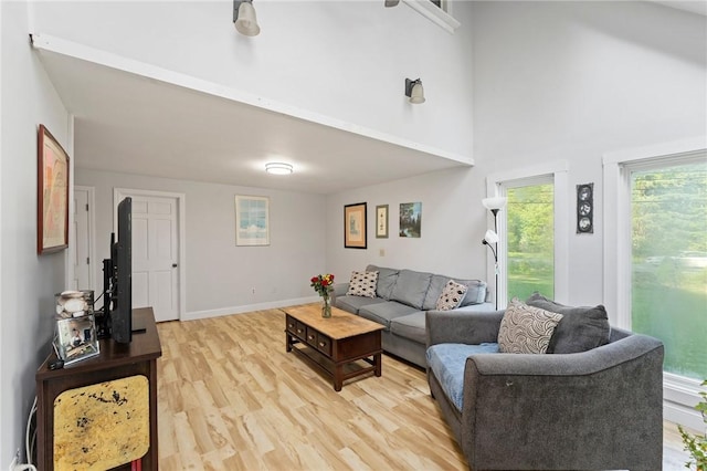 795 S Main St, Burrillville, RI 02859 - living area featuring a high ceiling, light wood finished floors, and baseboards