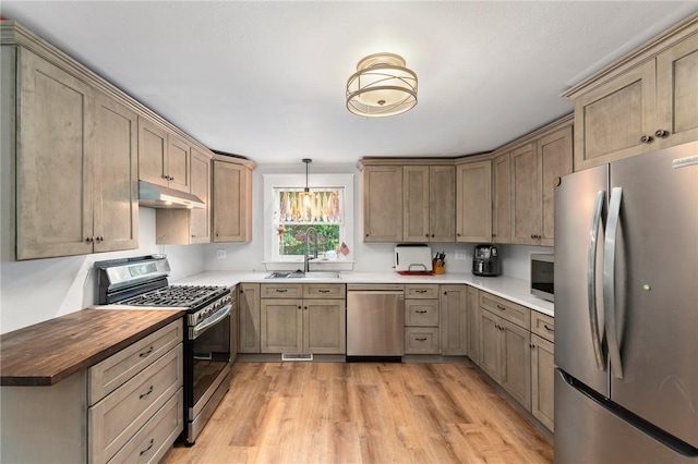 795 S Main St, Burrillville, RI 02859 - kitchen with stainless steel appliances, a sink, under cabinet range hood, butcher block countertops, and light wood-style flooring