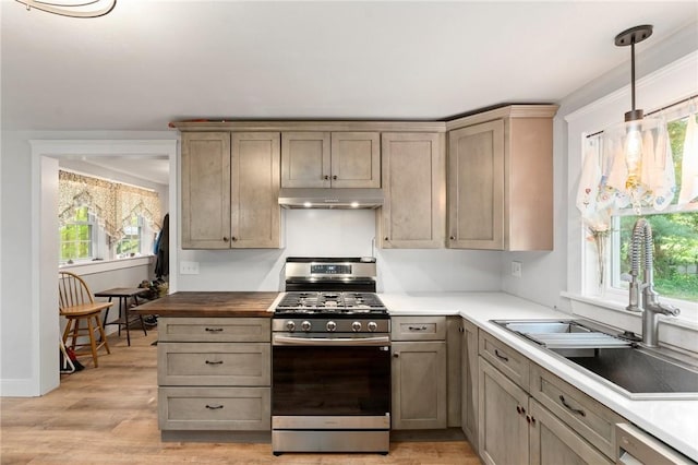 795 S Main St, Burrillville, RI 02859 - kitchen with gas stove, a sink, light wood-style floors, under cabinet range hood, and dishwashing machine