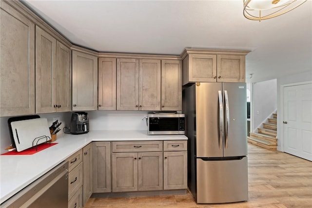 795 S Main St, Burrillville, RI 02859 - kitchen featuring stainless steel appliances, light wood-type flooring, and light countertops