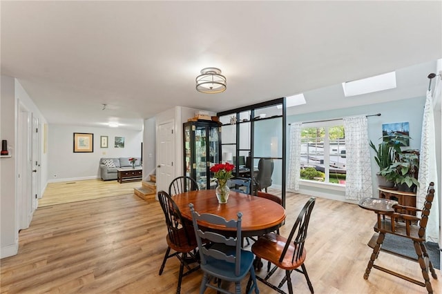 795 S Main St, Burrillville, RI 02859 - dining space with light wood-style floors, a skylight, and baseboards
