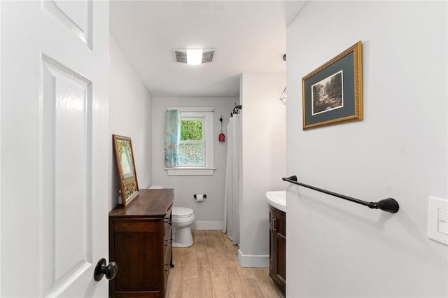 795 S Main St, Burrillville, RI 02859 - bathroom featuring vanity, wood finished floors, toilet, a shower with curtain, and baseboards