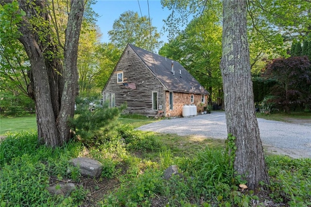 795 S Main St, Burrillville, RI 02859 - view of home's exterior featuring gravel driveway and a shingled roof