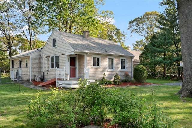 23 Abalone Rd, North Kingstown, RI 02874 - view of front of home with a chimney, a front lawn, central AC, and roof with shingles