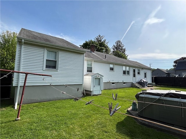 122 Cannon St, Cranston, RI 02920 - rear view of house featuring a chimney, a hot tub, and entry steps
