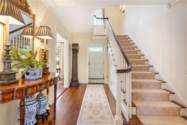 125 Grotto Ave, Providence, RI 02906 - foyer entrance with stairway, wood finished floors, baseboards, and arched walkways