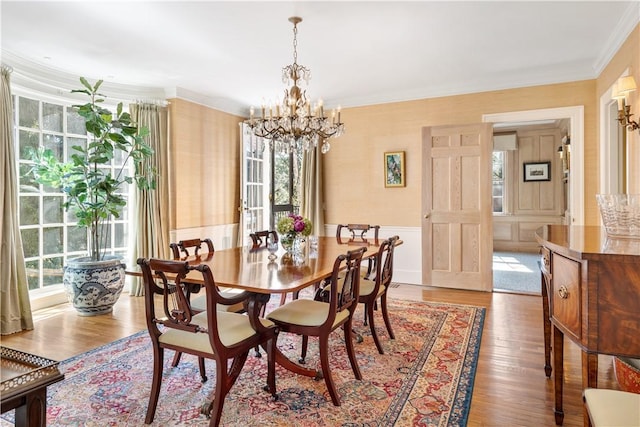 125 Grotto Ave, Providence, RI 02906 - dining space with a chandelier, crown molding, wood finished floors, and wallpapered walls