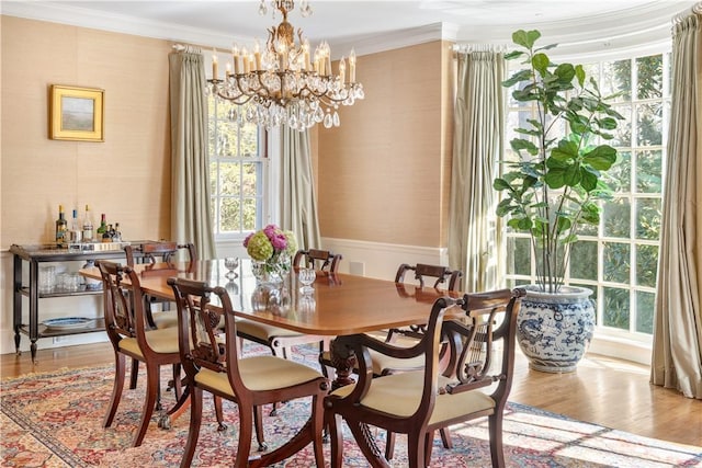125 Grotto Ave, Providence, RI 02906 - dining area with crown molding, wood finished floors, a chandelier, and wallpapered walls