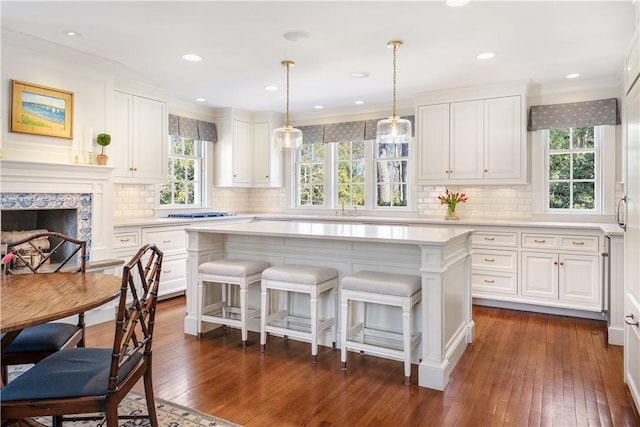 125 Grotto Ave, Providence, RI 02906 - kitchen featuring light countertops, healthy amount of natural light, white cabinets, and ornamental molding
