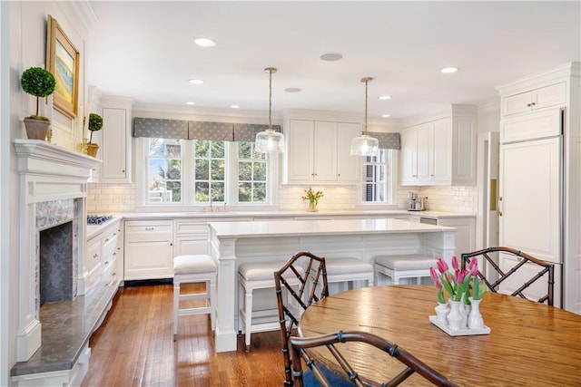 125 Grotto Ave, Providence, RI 02906 - kitchen featuring white cabinets, light countertops, backsplash, crown molding, and recessed lighting